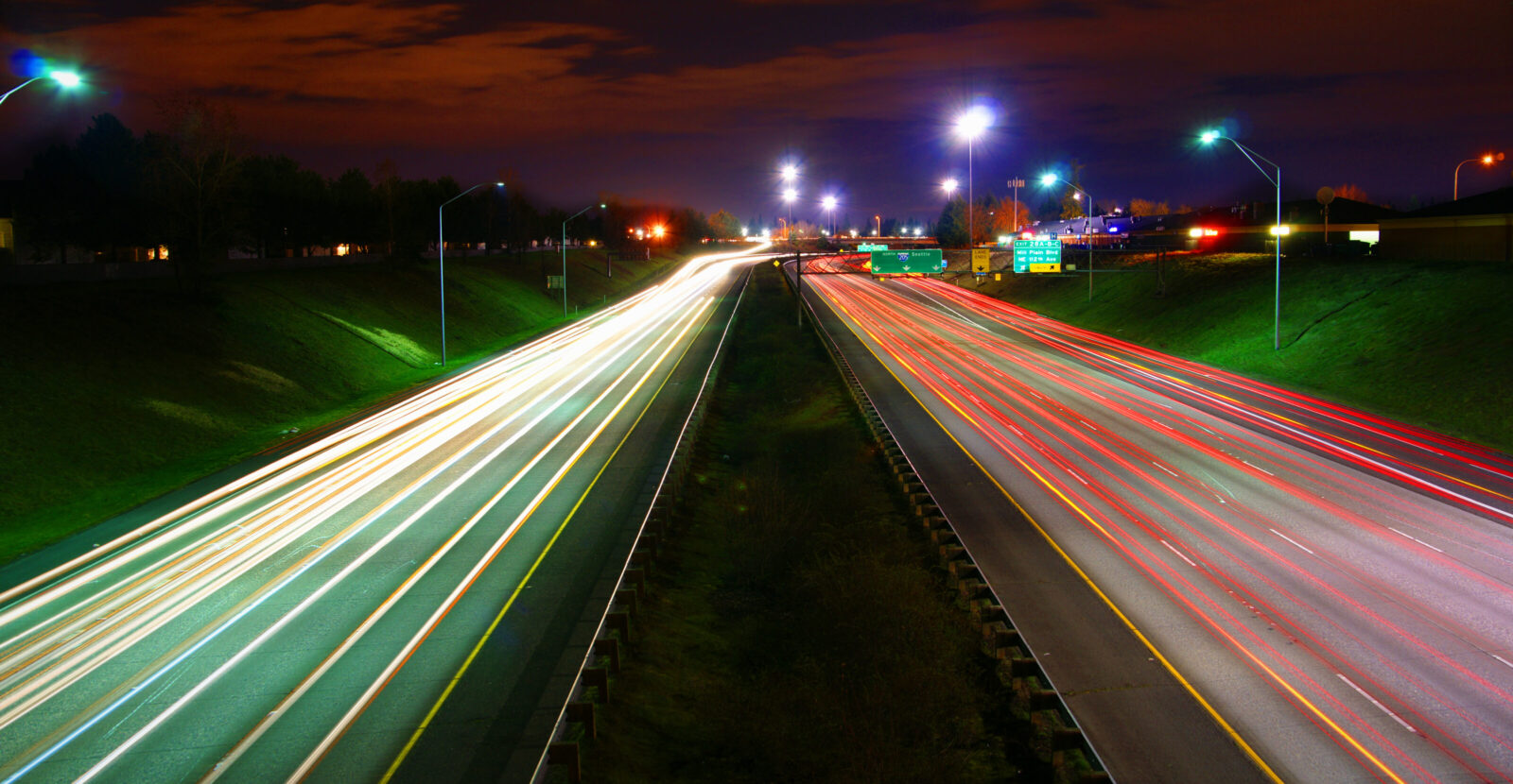 blurred traffic lights on an interstate at night