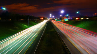 blurred traffic lights on an interstate at night