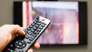 hand clicking TV remote